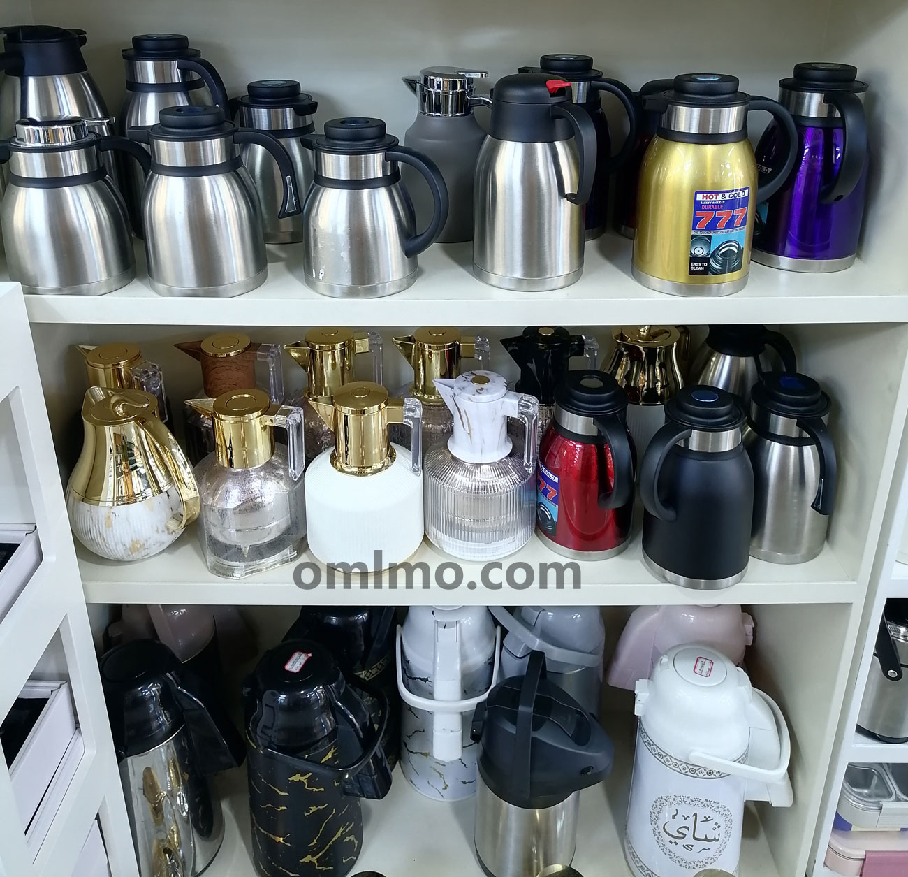 777 brand 304 stainless steel push-button vacuum flask multi-color series displayed on white shelving unit