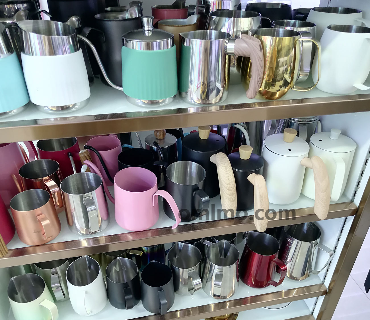 304 stainless steel lidded long-spout coffee latte art pitcher milk frothing pitcher collection displayed on three-tier shelf